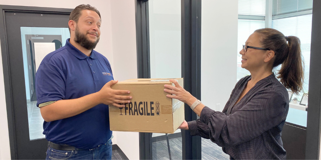 Driver handing off package to client