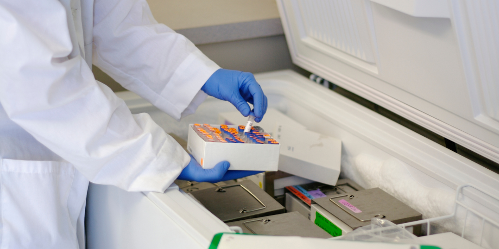 Individual in lab coat pull specimens out of freezer
