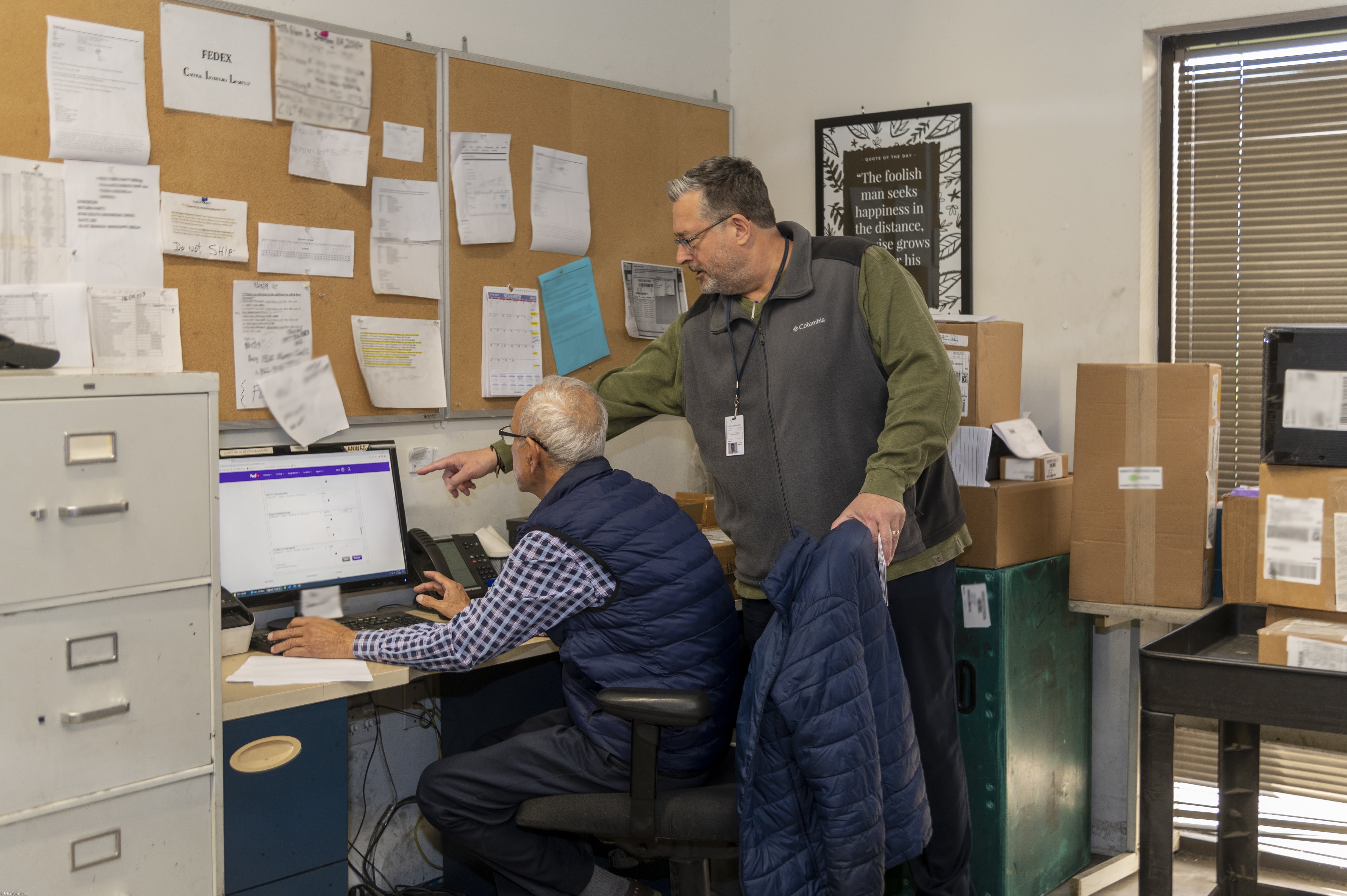 Logistics Management - manager pointing to computer
