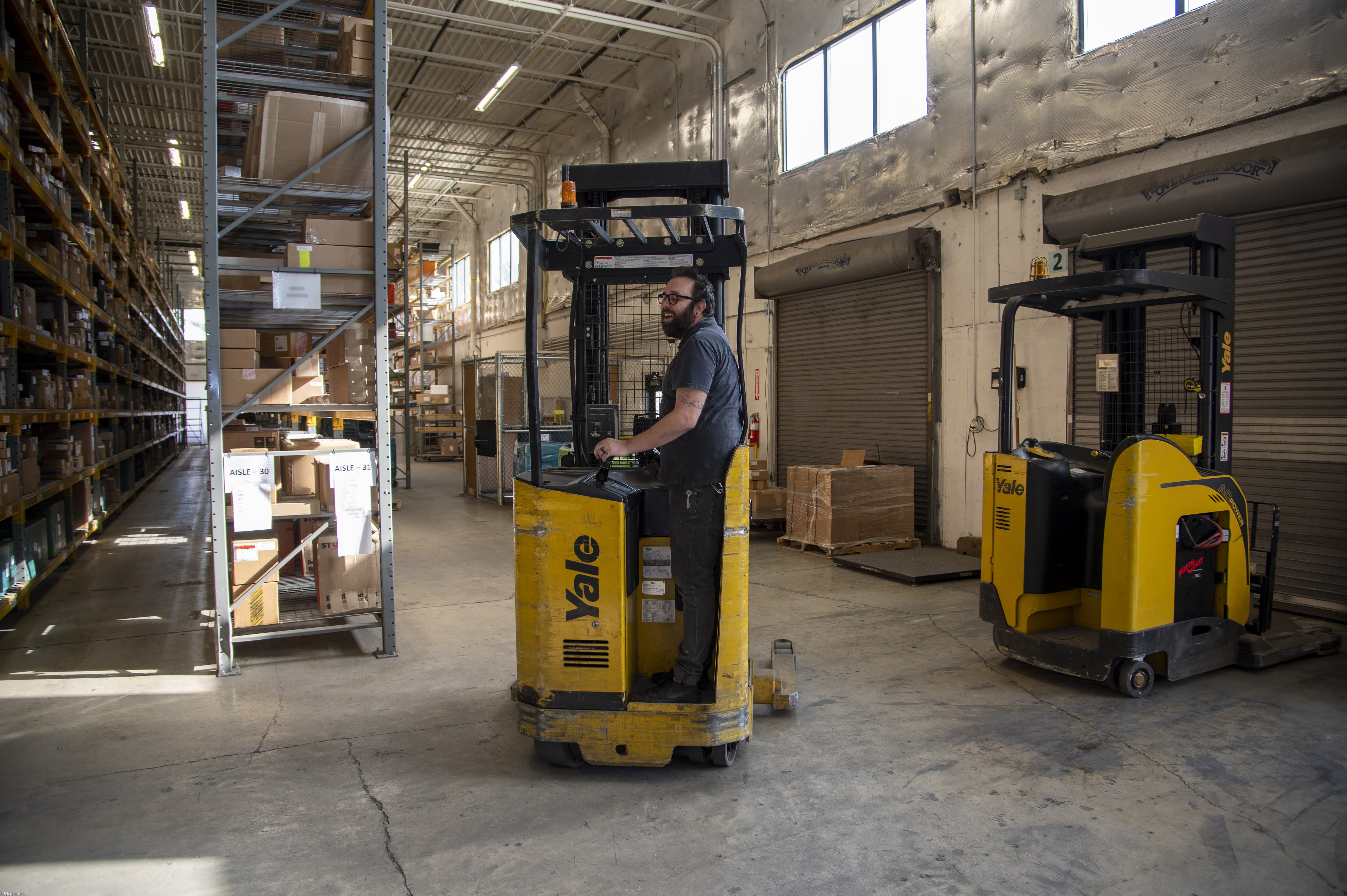 On forklift in warehouse